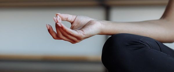 Close-up of hands in a mindful gesture during practice.
